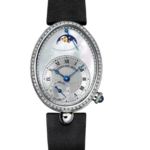 Oval diamond‑studded wristwatch with a mother‑of‑pearl dial, Roman numerals, blue hands, and a moon‑phase display at the top, mounted on a black fabric strap.