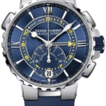Ulysse Nardin blue-dial wristwatch with a silver case, yellow accents, and a date window at 6 o'clock.