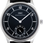 IWC Schaffhausen dress watch with black dial, white numerals, silver case, and black leather strap.