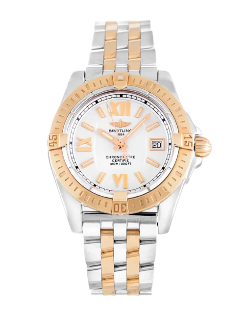 Two-tone Breitling watch with gold bezel and center links, white dial, Roman numeral markers, and date window at 3 o'clock.