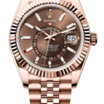 Rose gold Rolex Sky-Dweller watch with a fluted bezel, brown dial, and Jubilee bracelet showing date at 3 o'clock (28).