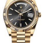 Gold Rolex Day-Date wristwatch with black dial, day and date windows, fluted bezel, and President bracelet.