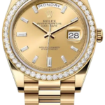 Gold Rolex Day-Date watch with diamond bezel and Jubilee bracelet; day window at 12 shows MONDAY, date 28 at 3 o’clock.