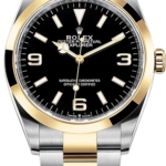 Two-tone Rolex Oyster Perpetual Explorer with black dial, gold bezel, and steel-and-gold bracelet in close-up.