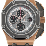 Audemars Piguet chronograph watch with a rose-gold case, gray dial, and black rubber strap.