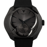 Close-up of a black Franck Vila Genève wristwatch with a dark brushed dial, minimal markers, and a small seconds subdial at 6 o'clock.