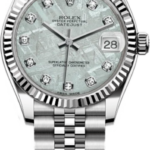 Rolex Datejust stainless steel watch with a fluted bezel, diamond hour markers, and a date window at 3 o'clock on a light dial.