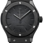 Black stainless steel wristwatch with a textured dark dial, silver hands, and a black leather strap.