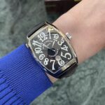 Wristwatch on a blue-sleeved arm: a black rectangular Franck Muller Casablanca with large white numerals