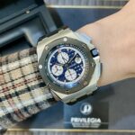 Wristwatch with a blue dial and white subdials on a metal bracelet, featuring an octagonal bezel with screws.