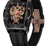 Cvstos luxury wristwatch with a black case and rose-gold skeleton dial featuring a detailed double-headed eagle, on a black rubber strap.