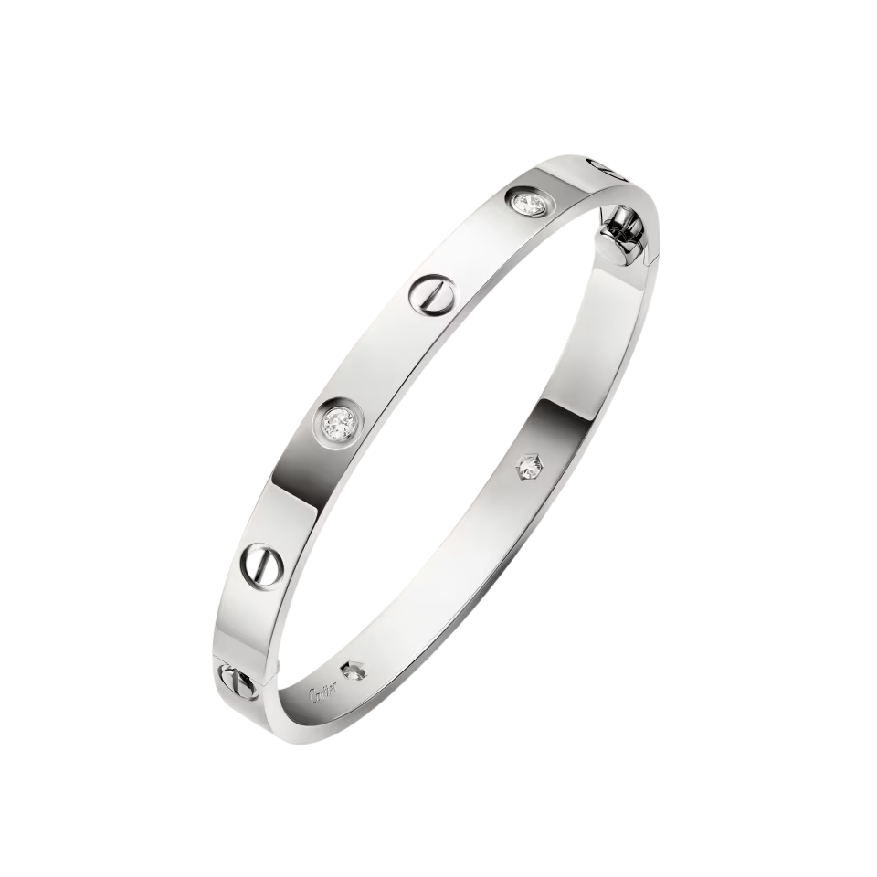 Silver Cartier Love-style bracelet: curved silver bangle with round diamonds set along the band against a black background