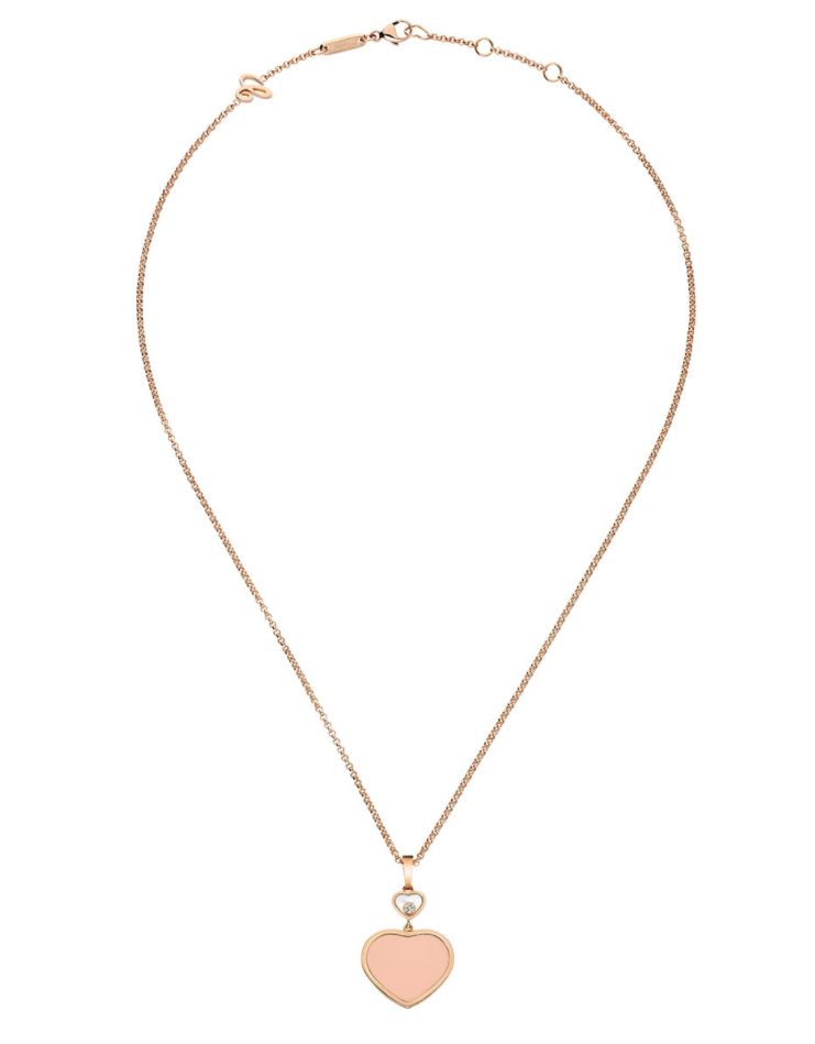 Delicate rose-gold chain necklace with a peach-pink enamel heart pendant framed in gold, laid flat on white.