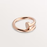 Rose gold open-ended ring with a smooth, polished band and a small raised pad detail, minimalist jewelry.