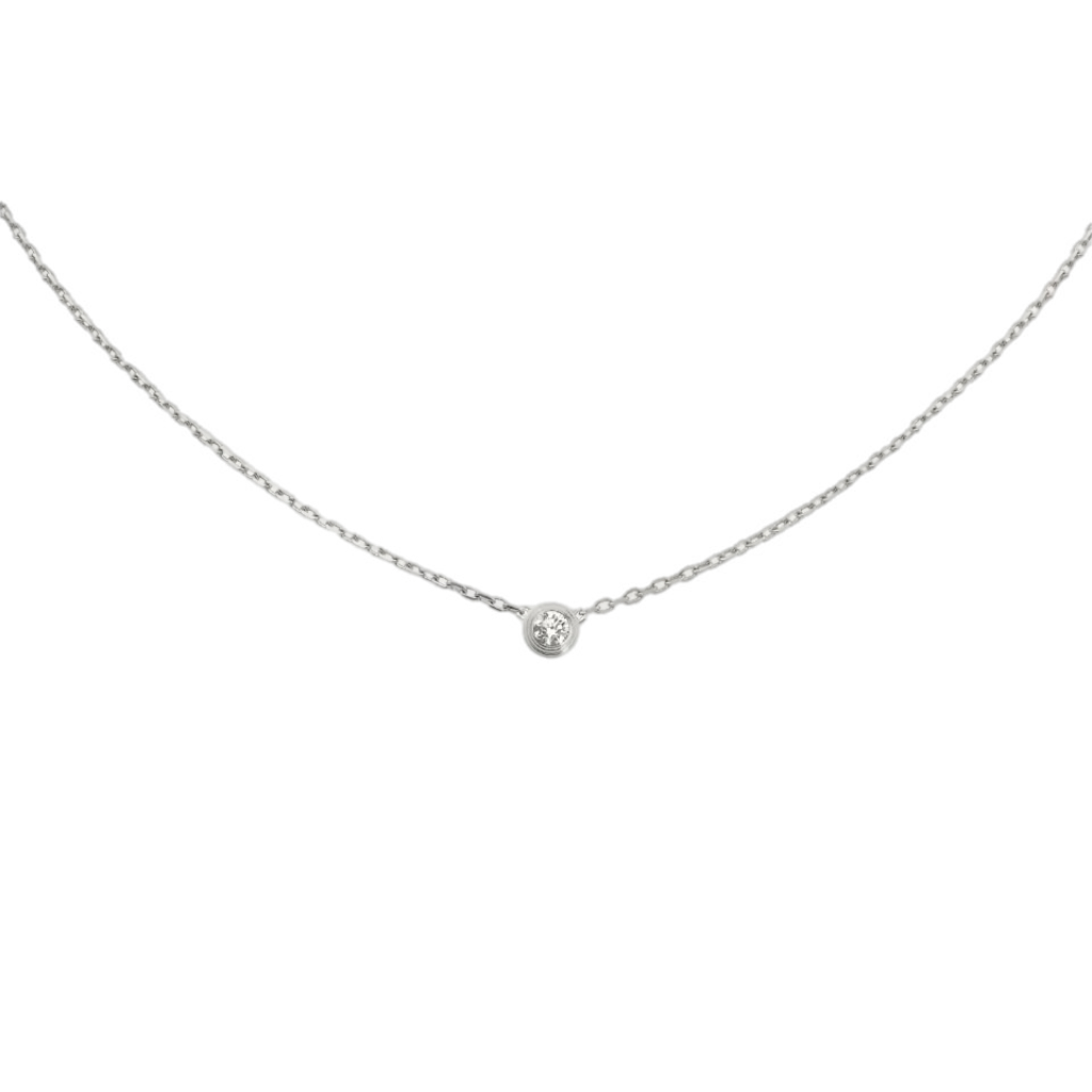 Delicate silver necklace with a small round diamond pendant on a black background.