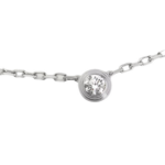 Silver necklace with a round bezel-set diamond pendant centered on a delicate chain.