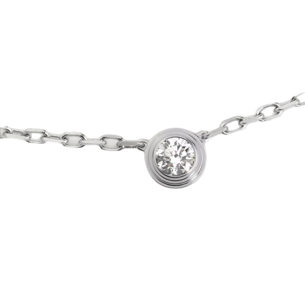 Silver necklace with a round bezel-set diamond pendant centered on a delicate chain.