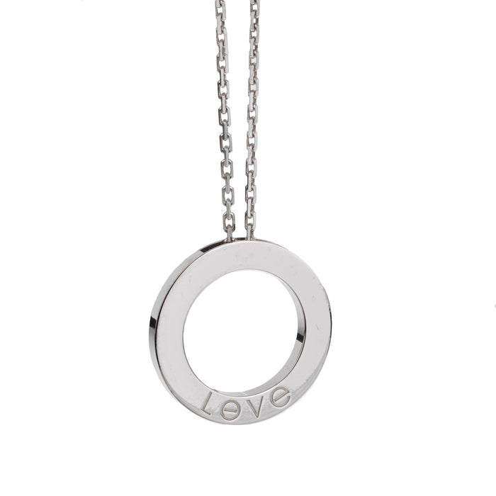 Circular silver pendant necklace with 'LOVE' engraved around the ring on a silver chain